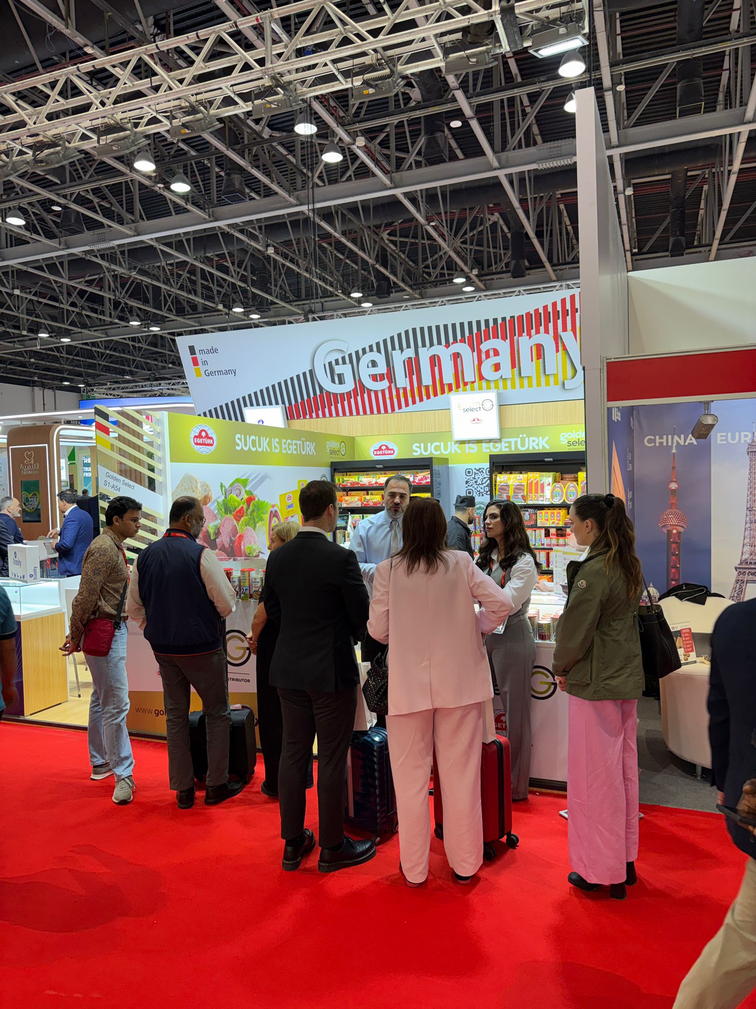 Visitors in conversation at the Golden Select stand